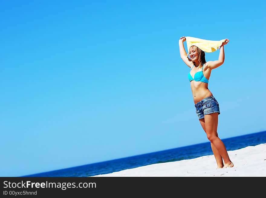 Young attractive woman enjoying summertime on the beach. Young attractive woman enjoying summertime on the beach