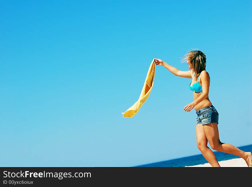 Young attractive woman enjoying summertime on the beach. Young attractive woman enjoying summertime on the beach