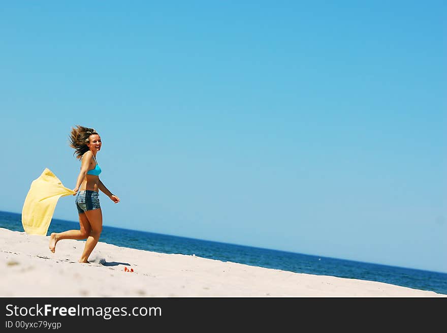 Young attractive woman enjoying summertime on the beach. Young attractive woman enjoying summertime on the beach