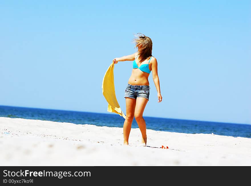 Young attractive woman enjoying summertime on the beach. Young attractive woman enjoying summertime on the beach