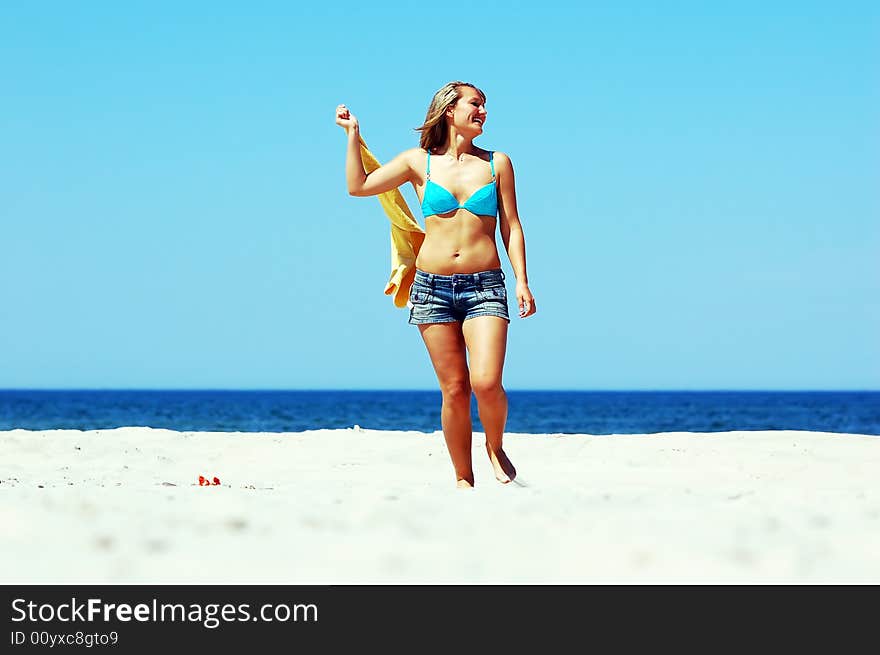 Young attractive woman enjoying summertime on the beach. Young attractive woman enjoying summertime on the beach