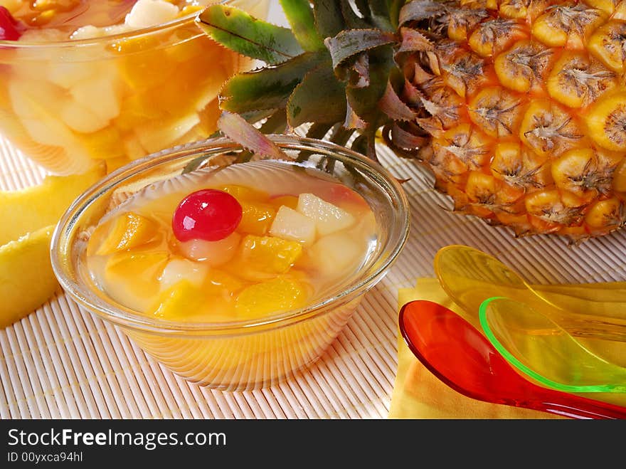 Fruit dessert in a bowl and a pineapple