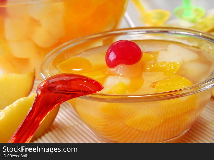 Fruit dessert in a bowl and a red spoon