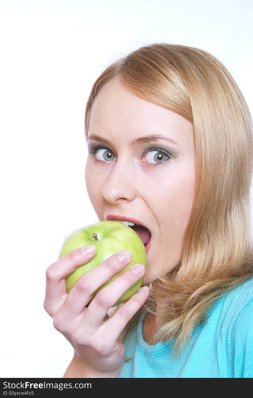 The girl on a white background bites an apple. The girl on a white background bites an apple