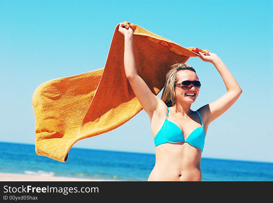 Young attractive woman enjoying summertime on the beach. Young attractive woman enjoying summertime on the beach