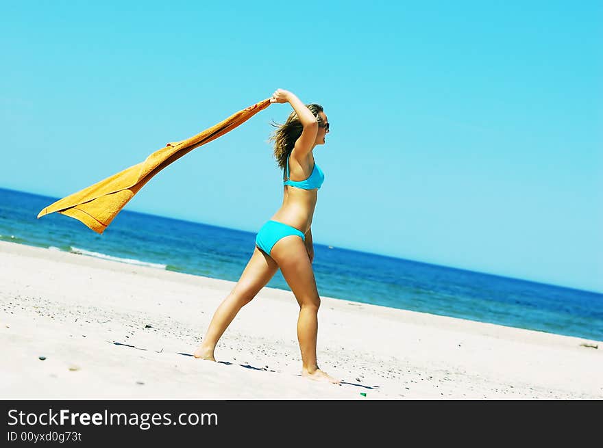 Young attractive woman enjoying summertime on the beach. Young attractive woman enjoying summertime on the beach