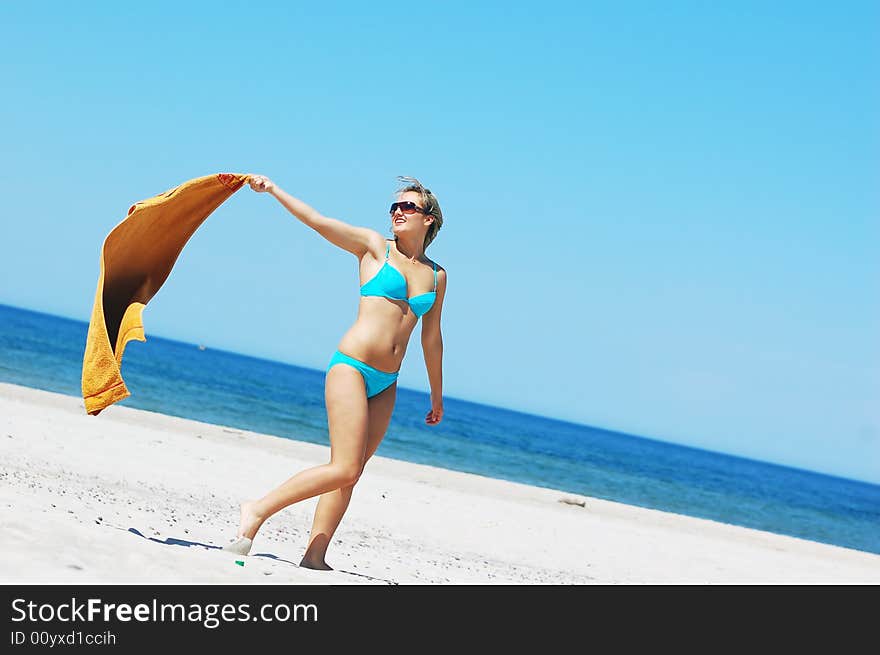 Young attractive woman enjoying summertime on the beach. Young attractive woman enjoying summertime on the beach