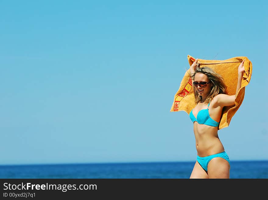 Young attractive woman enjoying summertime on the beach. Young attractive woman enjoying summertime on the beach