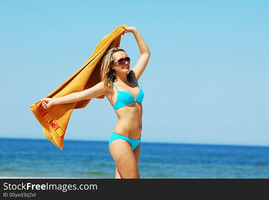 Young attractive woman enjoying summertime on the beach. Young attractive woman enjoying summertime on the beach