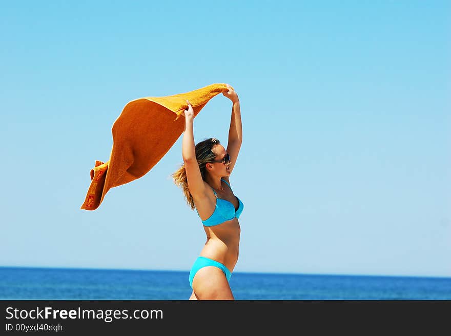 Young attractive woman enjoying summertime on the beach. Young attractive woman enjoying summertime on the beach