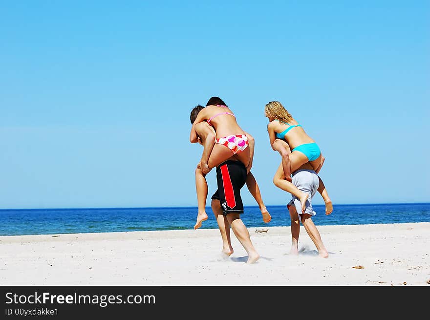 Young attractive friends having fun the summer beach. Young attractive friends having fun the summer beach