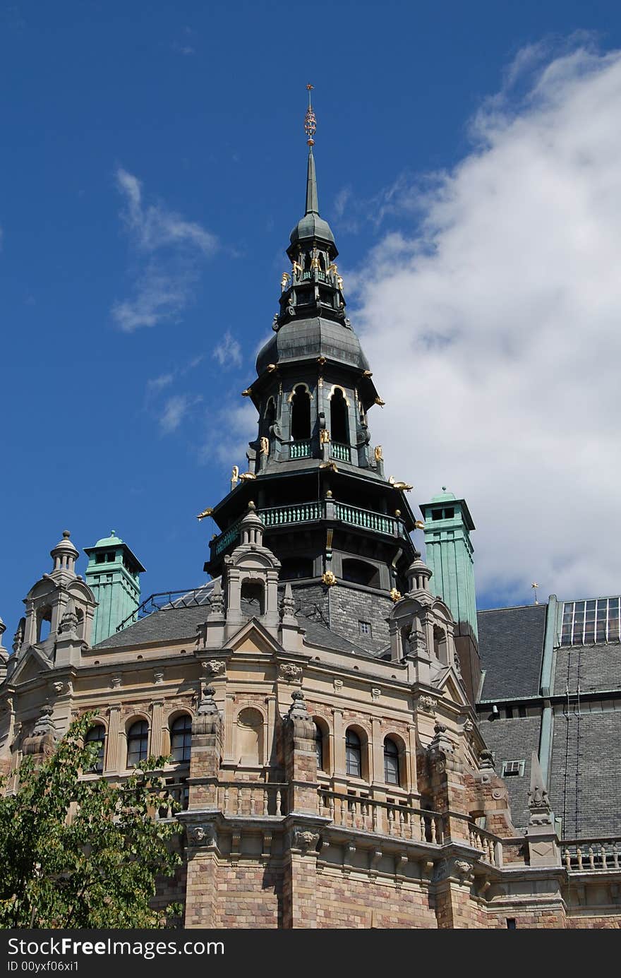 An old church from the 18th century with intricate details and oxidation on the metal parts of the steeple.