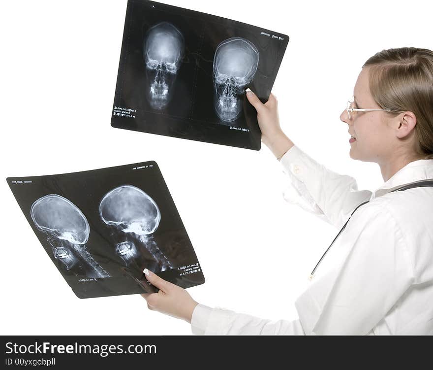 Young and beautiful doctor looking at x-ray. Young and beautiful doctor looking at x-ray