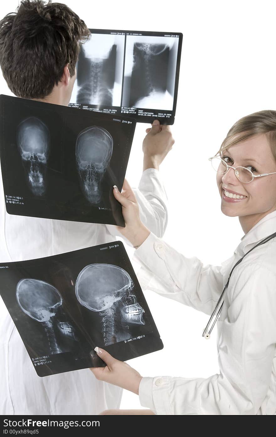 Young and beautiful doctor looking at x-ray. Young and beautiful doctor looking at x-ray