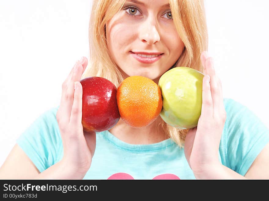 The girl on a white background gives fruit. The girl on a white background gives fruit