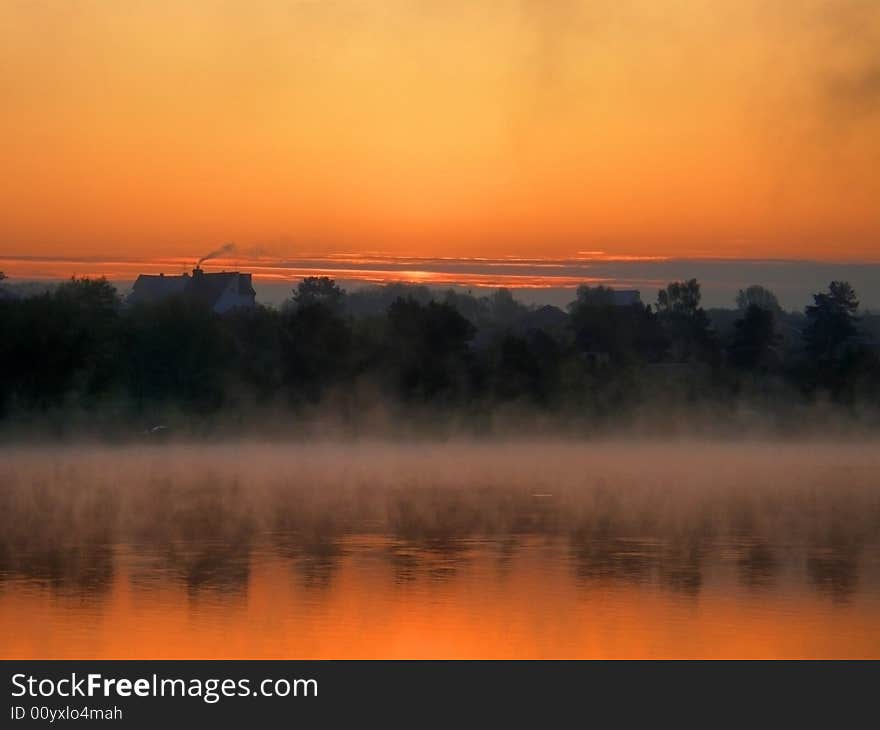 Misty morning on a lake with wonderful dawn. Misty morning on a lake with wonderful dawn