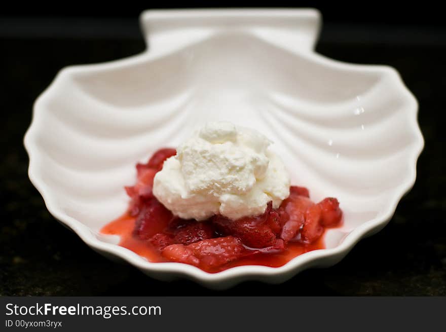 Strawberry and whipped cream dessert in a clamshell bowl. Strawberry and whipped cream dessert in a clamshell bowl