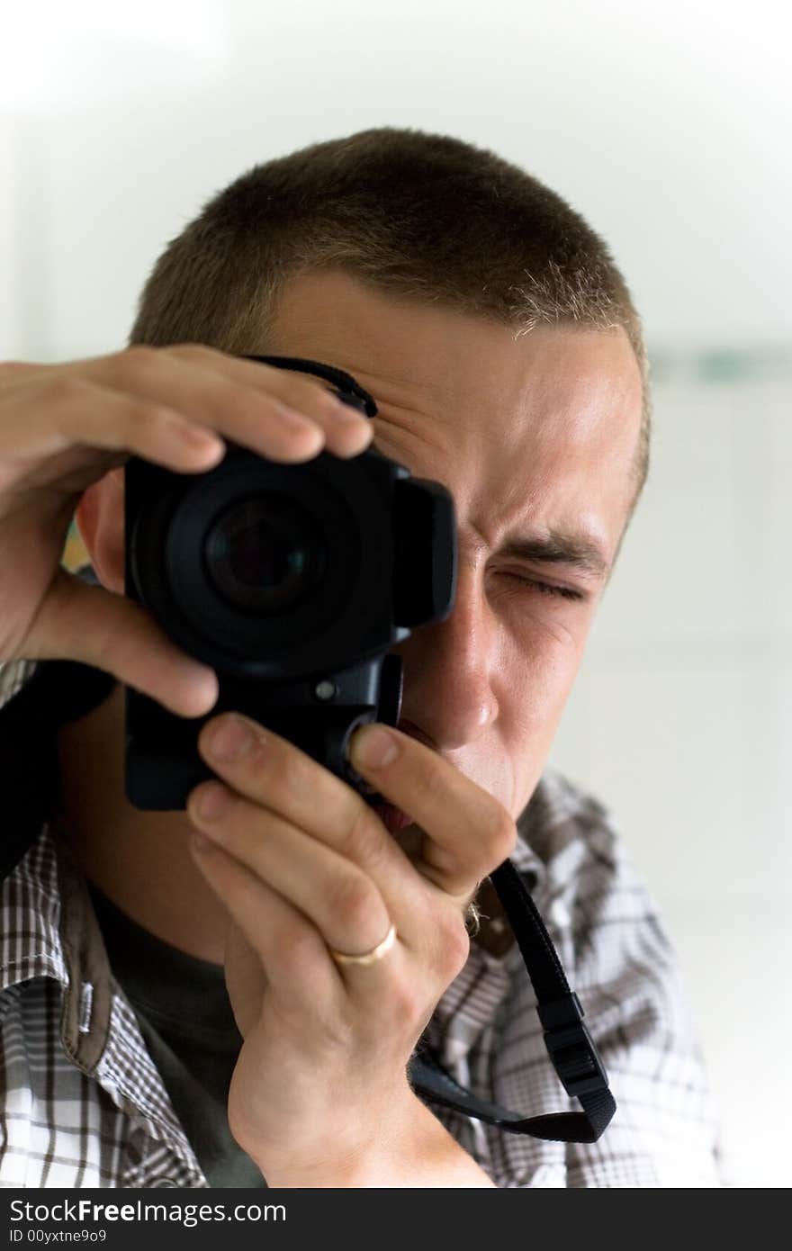 Man with photo camera indoor. Man with photo camera indoor