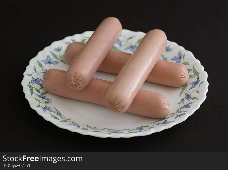 Several sausages by closeup against the black background