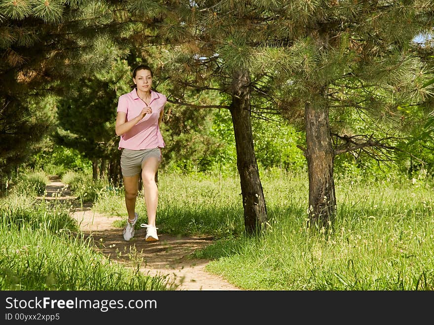 A female runner in a field, note there is some motion blur