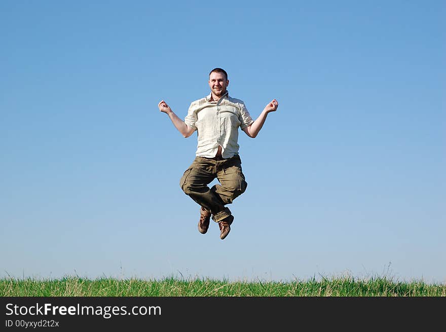 Happy man jumping on green meadow. Happy man jumping on green meadow