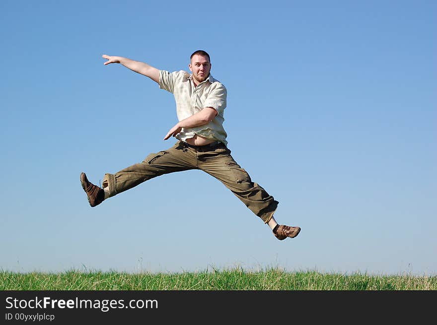 Happy man jumping on green meadow. Happy man jumping on green meadow