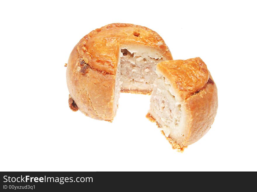 Cut pork pie isolated on a white background