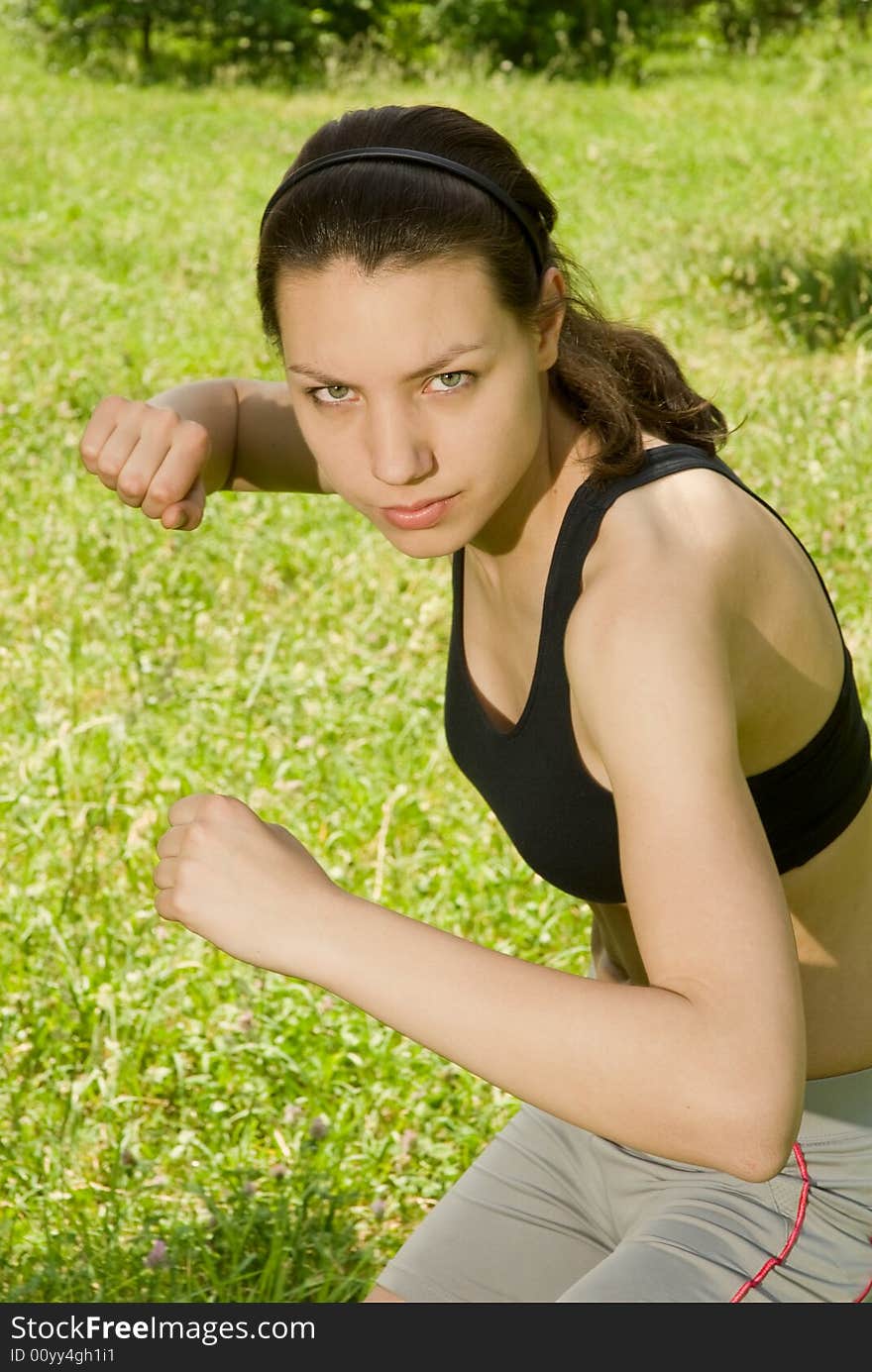 Sporty girl clenches her fists. Sporty girl clenches her fists