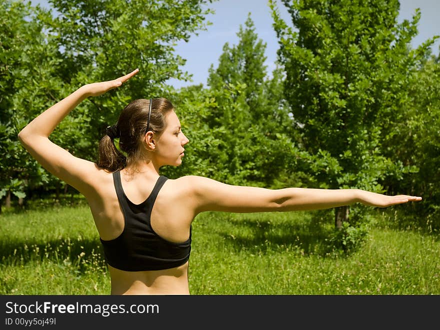 Sporty girl making yoga outdoors