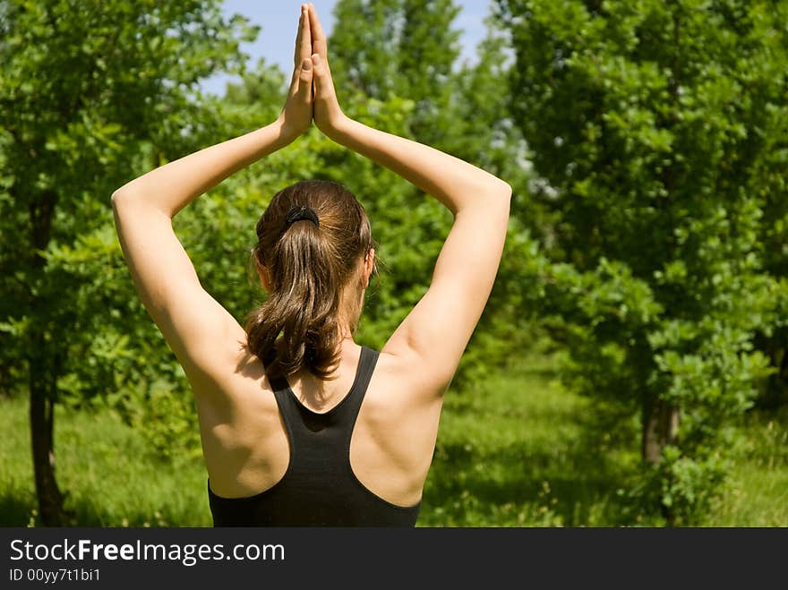 Sporty girl making yoga outdoors