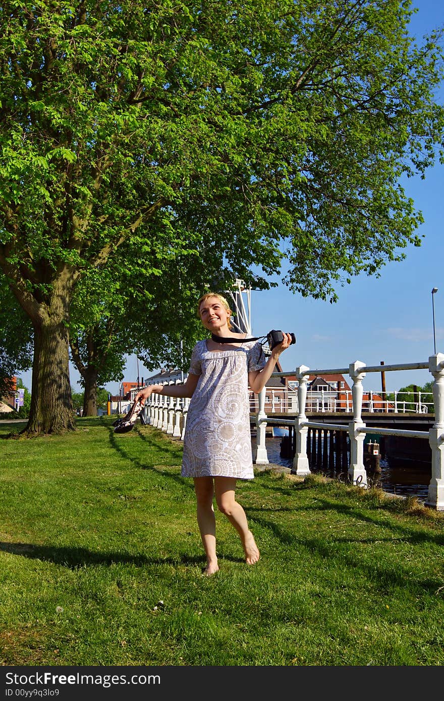 Happy woman with a photo camera outdoor