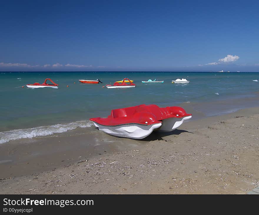 Red peddle craft on beach