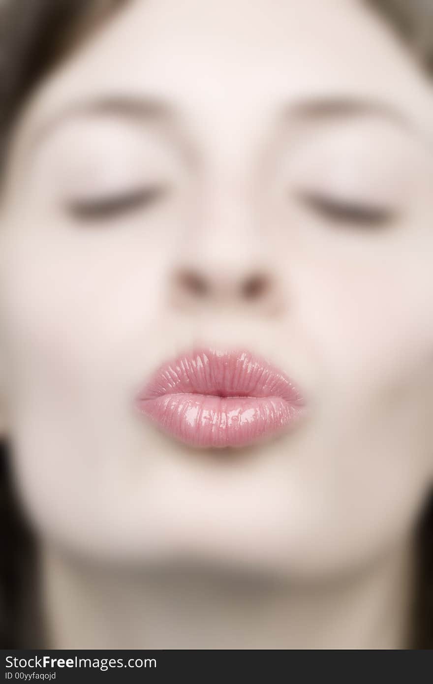 Portrait of a young woman giving a kiss