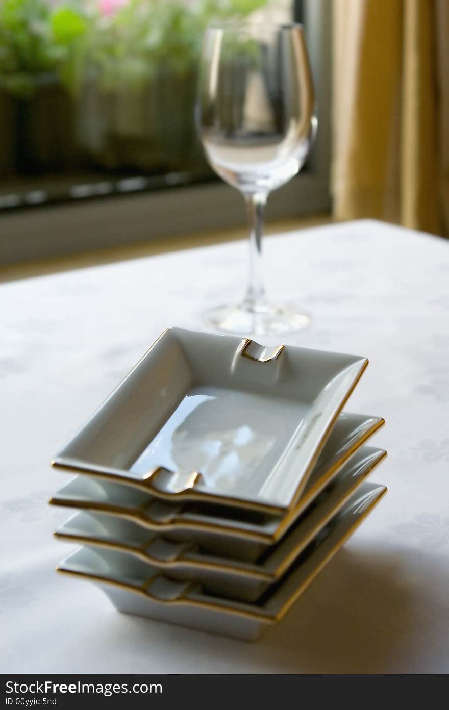 Ashtrays and glass at restaurant