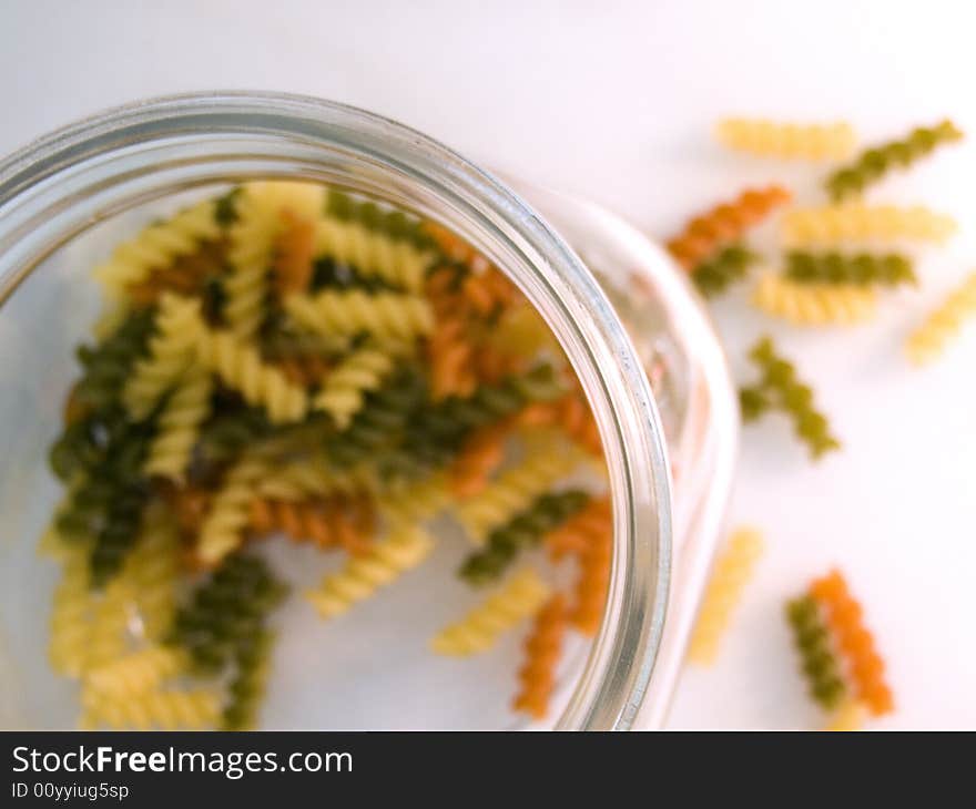 Coloured pasta with soft focus on the pot