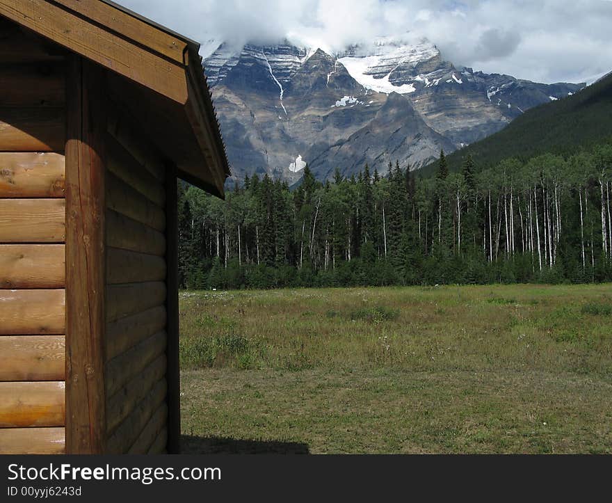 Wood cabin at the foot of the mountains