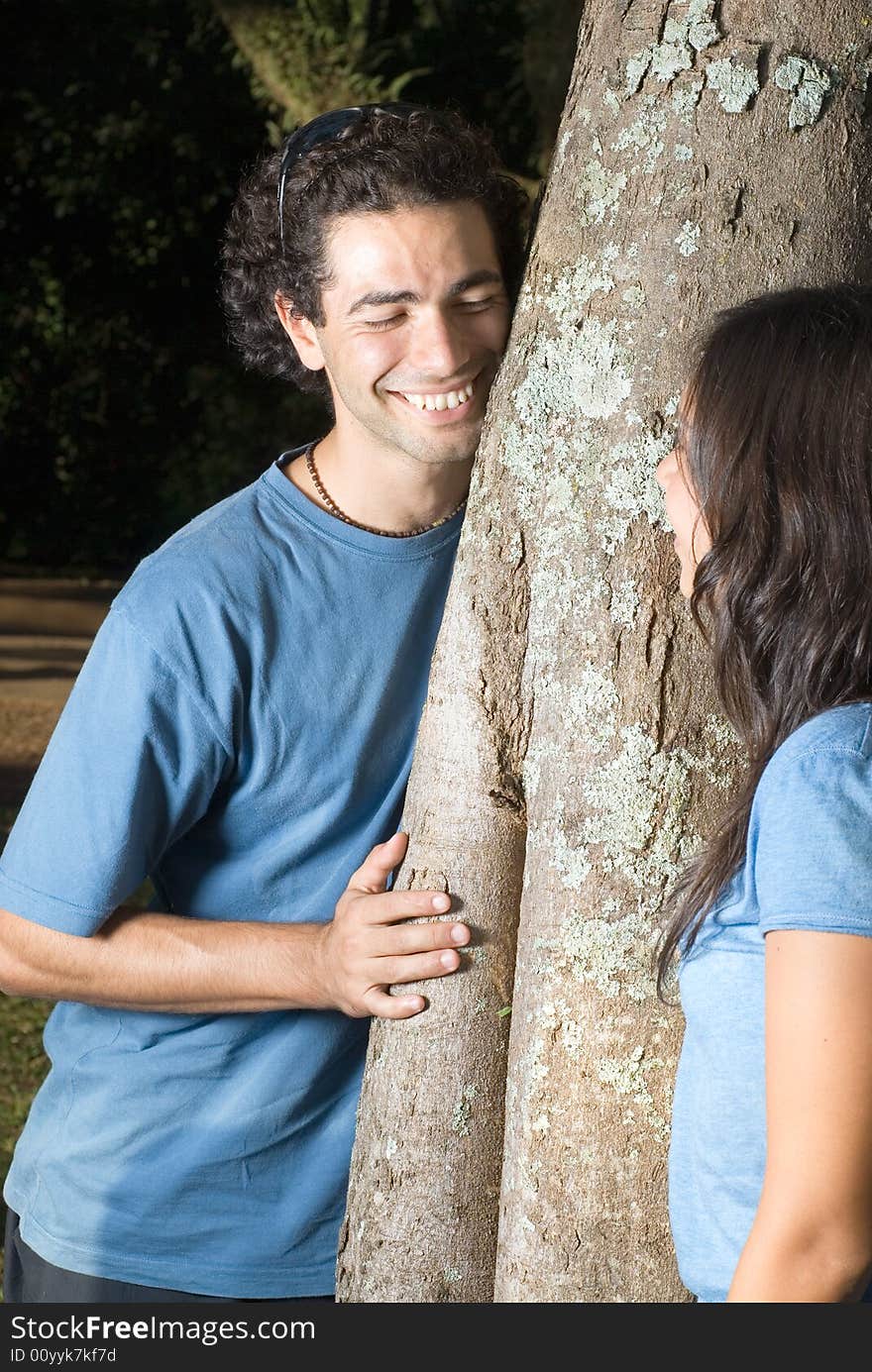 Couple Leaning Against A Tree - Vertical