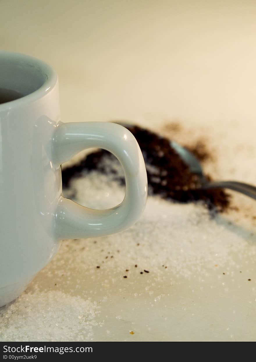 Mug focus, coffe and sugar in the background. Mug focus, coffe and sugar in the background