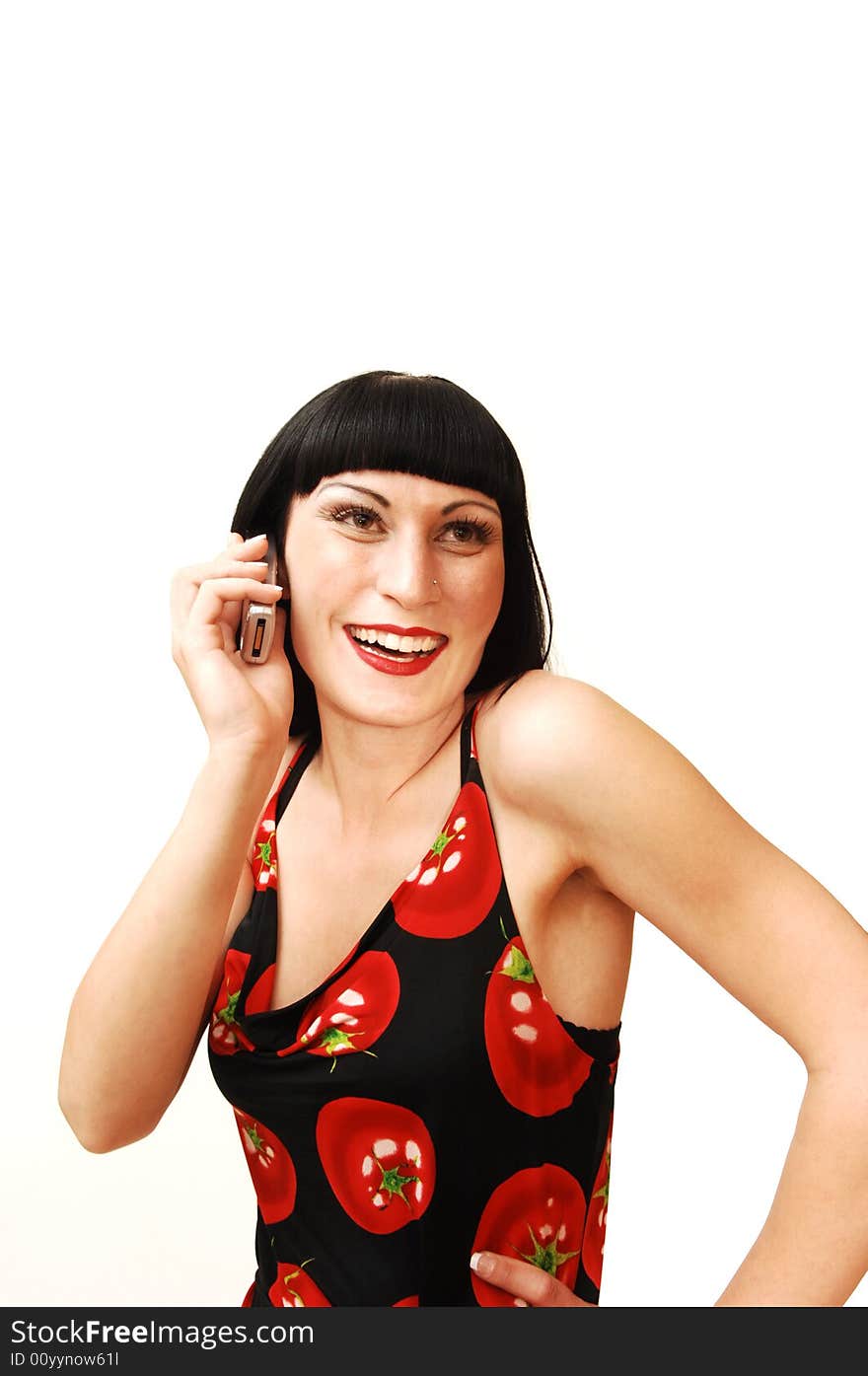 A young pretty woman standing in a studio and having fun talking
on the cell phone for white background in a tomato print dress. A young pretty woman standing in a studio and having fun talking
on the cell phone for white background in a tomato print dress.