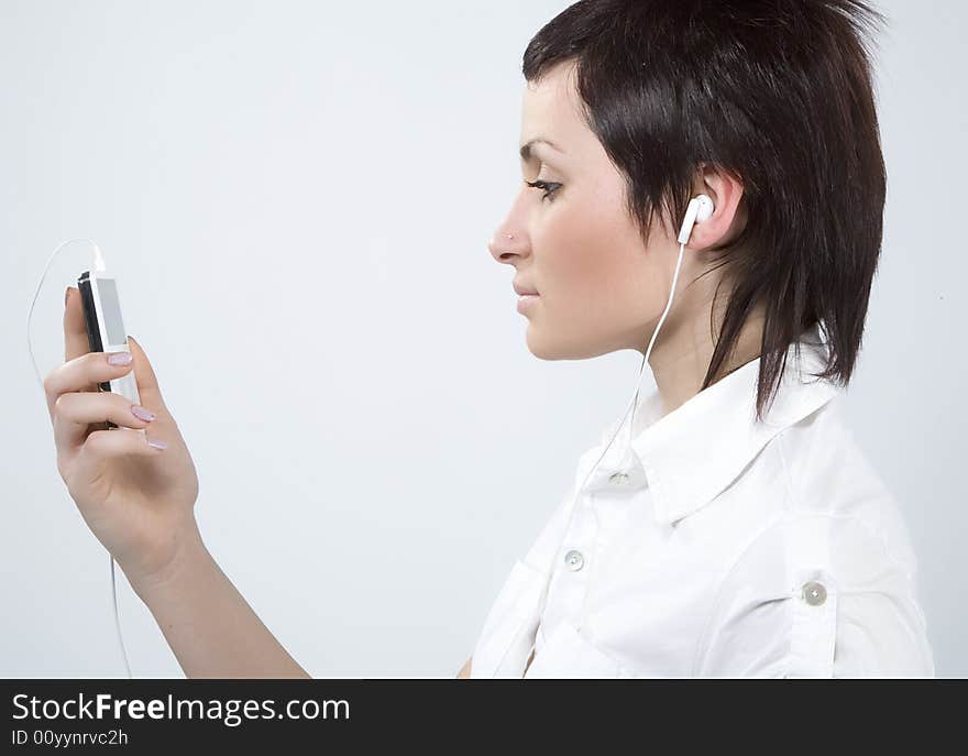 Girl with Mp3-player listening to the music