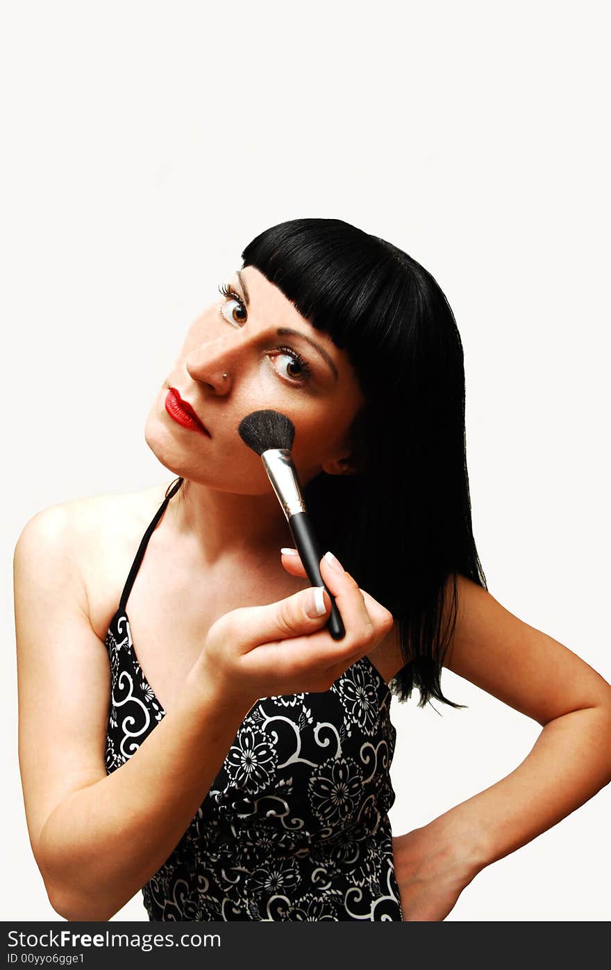 An young pretty girl in a black and white dress putting new make-up on,
standing in an studio for white background. An young pretty girl in a black and white dress putting new make-up on,
standing in an studio for white background.