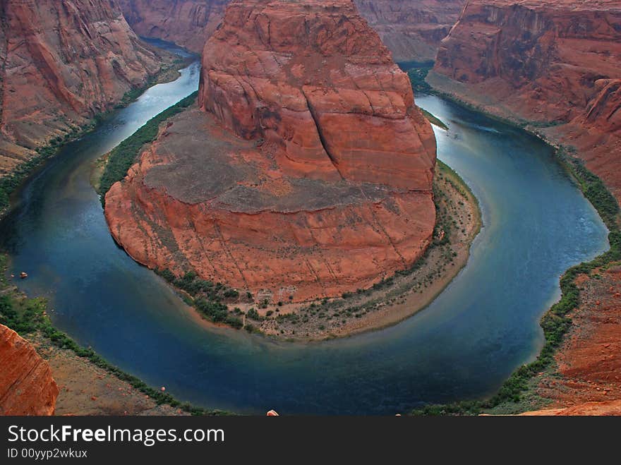 Dramatic bend in river around red cliff. Dramatic bend in river around red cliff