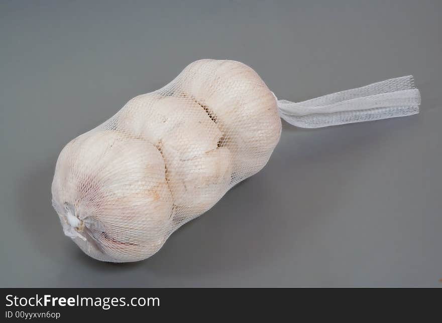 Three garlic bulbs in a net