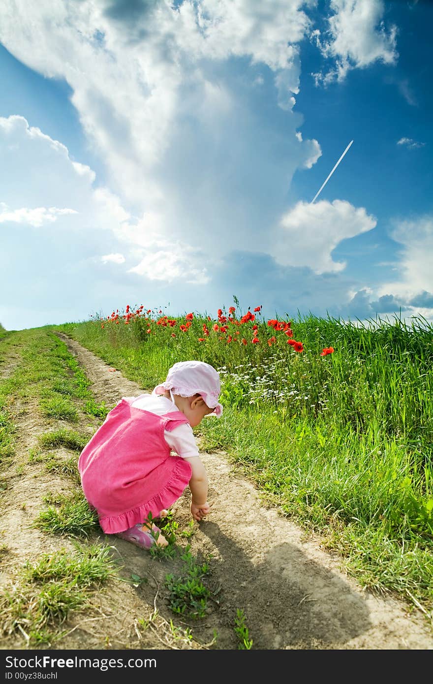 Baby on a lane amongst a field