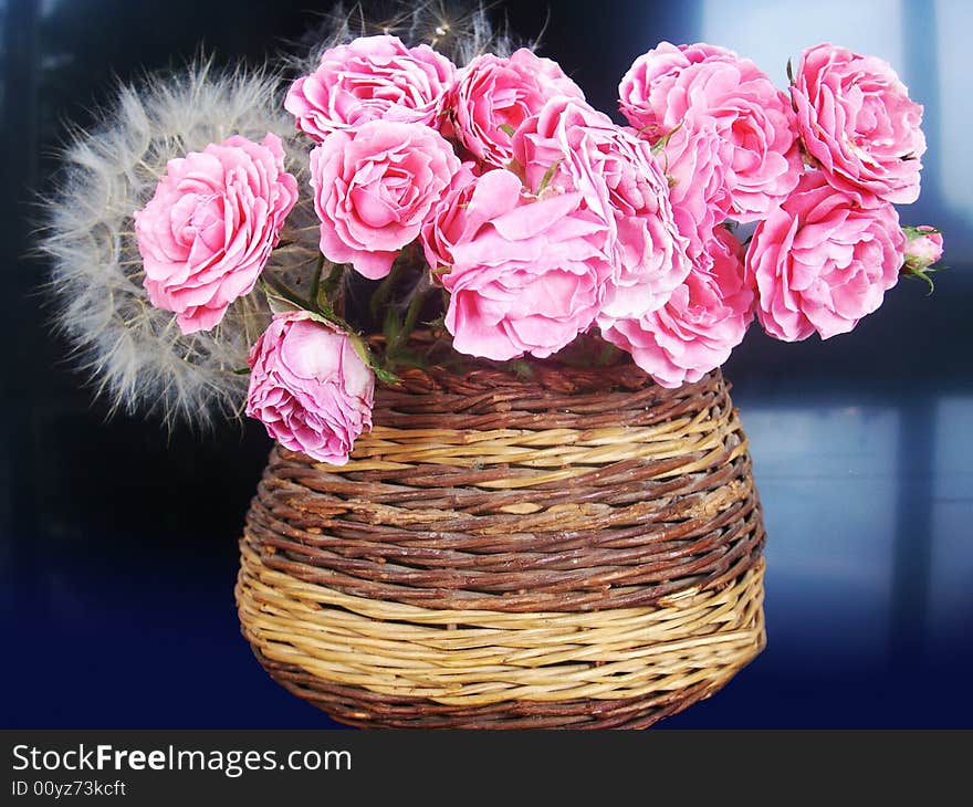 Beautiful pink flowers in wood vase is a perfect gift