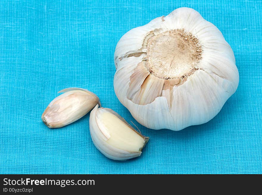 Garlic close up on a blue fabric. Garlic close up on a blue fabric