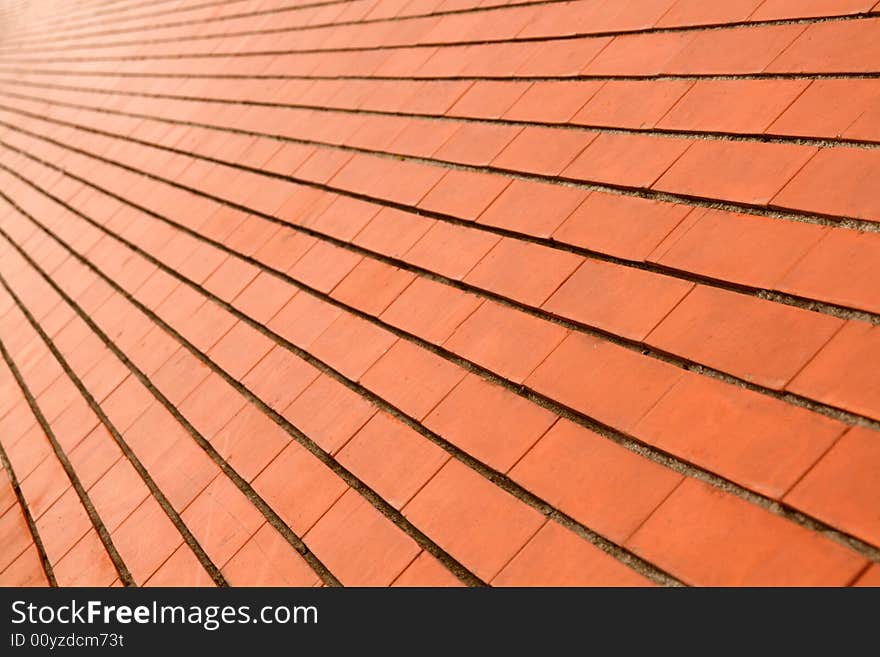 Background of a diagonal red orange brick wall. Background of a diagonal red orange brick wall