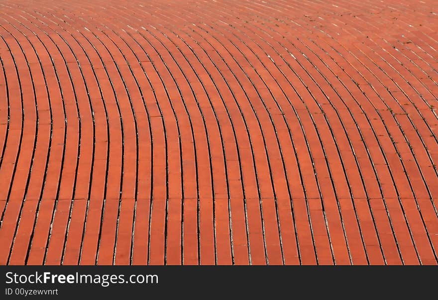 Background of a curve red orange brick wall. Background of a curve red orange brick wall