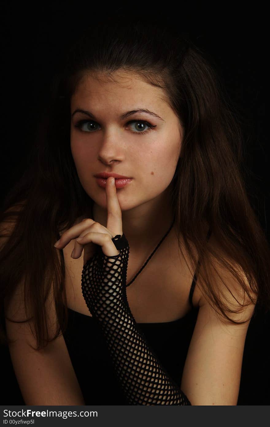 Young girl with a finger near the lips