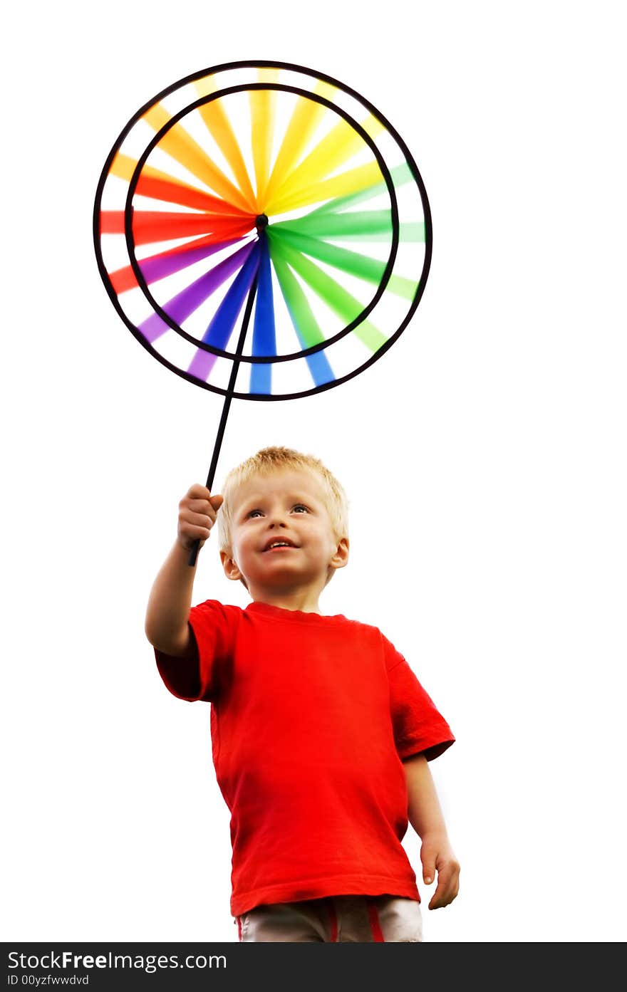 Little boy holds up a toy windmill over a white background. Little boy holds up a toy windmill over a white background